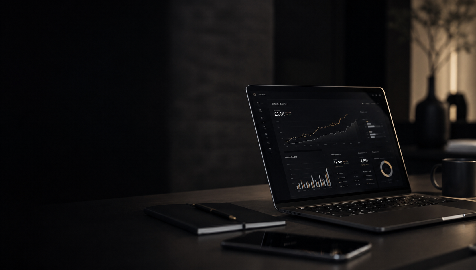 Dark moody workspace with laptop showing visibility analytics dashboard